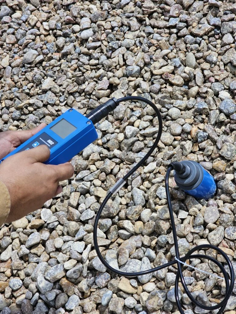 Taking a portable moisture reading directly in an aggregate stockpile