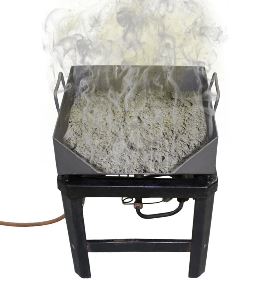 Aggregate sample being dried to constant mass over a burner for total evaporable moisture determination